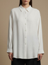 Long shirt with classic collar and oversized cuffs in white